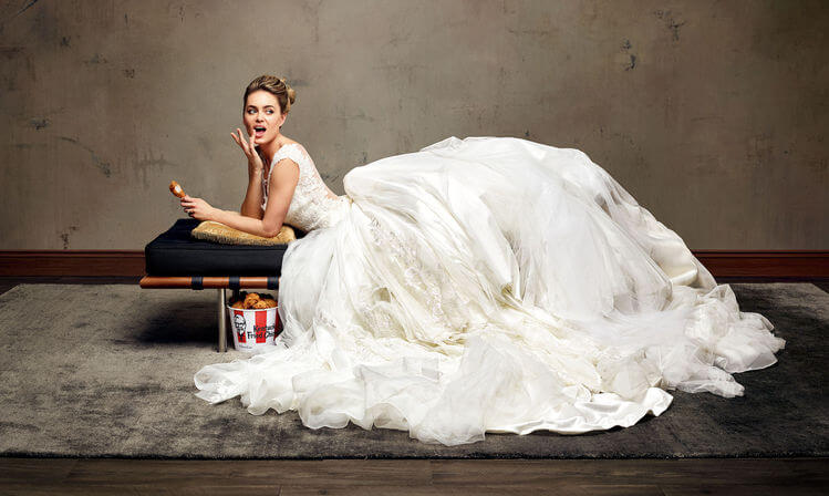 The bride enjoying the a fried chicken on wedding